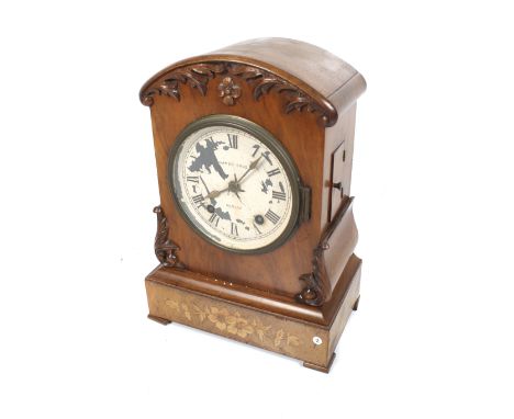 A Victorian 8 day walnut cased mantel clock with painted dial. Striking to a gong, inscribed 'Gamer Bros., Dublin' with Roman