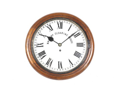 A vintage circular wall clock 'Railway Clearing House'. A mahogany cased fusee wall clock. White painted dial with black Roma