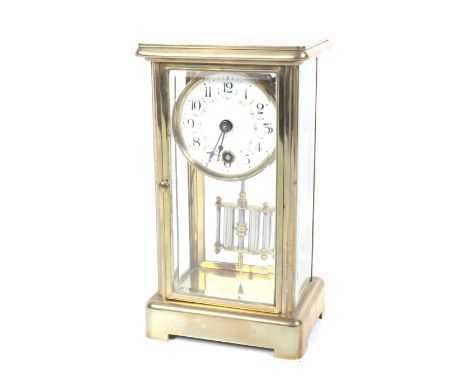A small four glass brass cased mantel clock. A white dial with floral swags, Arabic numerals. H21cm