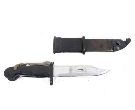 An AK47 Kalashnikov bayonet with a wire cutter scabbard. Blade length 14.8cm, with a metal grip