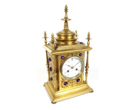 Howell James & Co gilt metal mantel clock. Striking to a bell, white enamel dial, Roman numerals and minute markers. Turned m