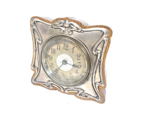 A British United Clock Co Ltd mantel clock. A brass drum cased mechanism set in a wood mount with an Art Nouveau silver hall 