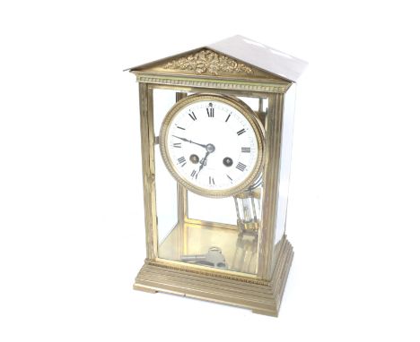 A French Couillet Freres 8 day brass cased mercury pendulum mantel clock. Four glass, striking to a gong, white enamel dial w