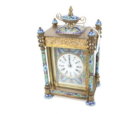 A French 8 day striking brass and cloisonne mantel clock. Decorated with painted figures of young women on the side panels. C