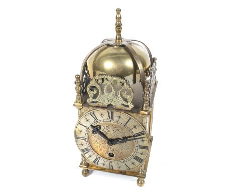 A 20th century Smiths brass lantern clock. #EW264/53, unadjusted 7 jewels movement, with pierced 'dolphin' decorated, H25cm.