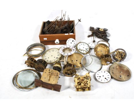 A collection of assorted vintage mechanical clock mechanisms and parts. Including dial covers, springs, mechanisms, etc.