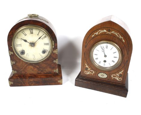 Two vintage arched top wood cased mantel clocks. One with an inlaid decorative oak case, white enamel dial and Roman numerals