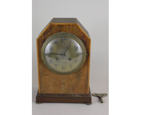 An inlaid mahogany cased mantle clock the brass dial with Arabic numerals, striking on a gong