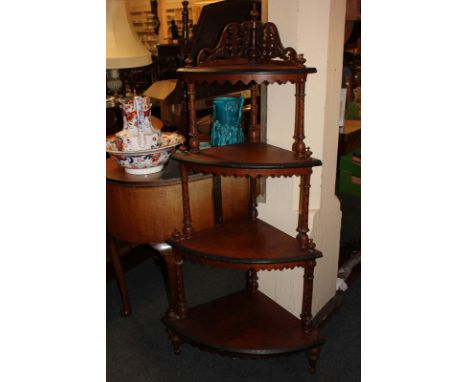 A mahogany four-tier corner whatnot, each shelf with shaped apron, on turned supports, 137cm