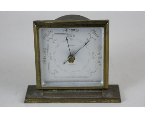 A Shortland Smiths brass table barometer with square dial, on rectangular base, 10cm