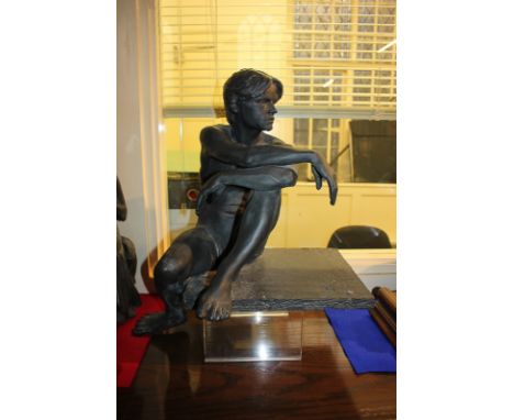 A 20th century matte bronze glazed and waxed slip cast ceramic sculpture of a seated nude man 'Chris'  by Walter Awlson (a/f)