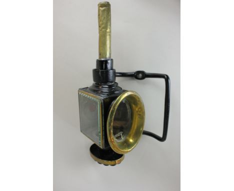 A black painted metal and brass coach lamp (a/f - crack to glass), and supporting bracket
