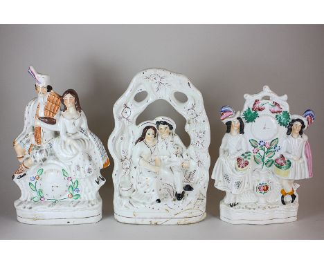 Three Staffordshire pottery flat back figure groups including a man, woman and spaniel in pierced surround, a Scottish lord a