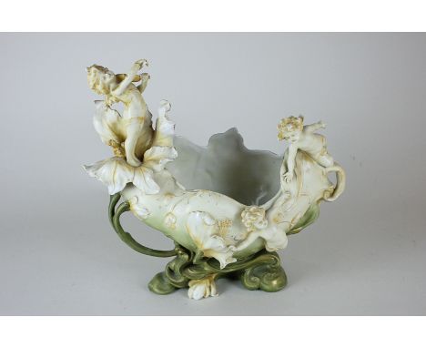 A Continental Art Nouveau style vase depicting a putti playing a violin in a flower with other putty amongst flower buds on n