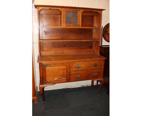 An early 20th century oak dresser with two-shelf back and lead glazed cupboard, on base with cupboard and two drawers (one no