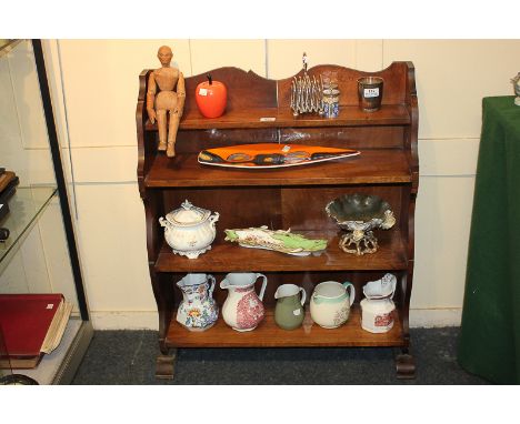 A Victorian bookcase with narrow top shelf and three further shelves, on shaped supports, 75cm