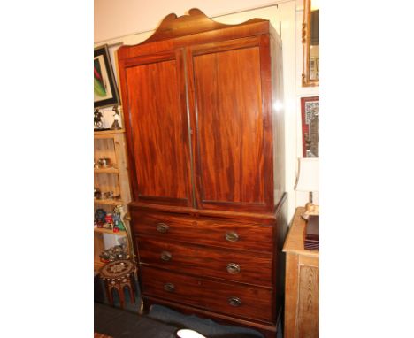 A 19th century inlaid mahogany press cupboard with domed cornice, two panelled doors enclosing four trays, on base with three
