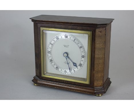 An Elliott mantel clock with square silvered dial, on plinth base and brass button feet, 16cm