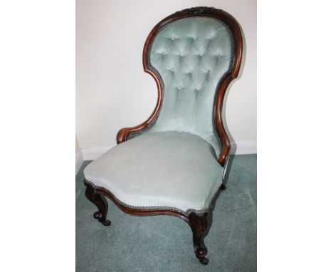 A Victorian rosewood framed chair with moulded and shaped button back and serpentine seat, on cabriole front legs with scroll