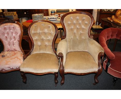 A Victorian button upholstered armchair and another fireside chair, in matching beige upholstery, on scroll legs and castors