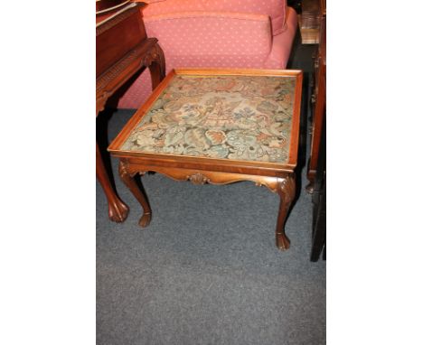 A mahogany rectangular occasional table with glazed tapestry top, on shell capped cabriole legs and shaped frieze, 70cm