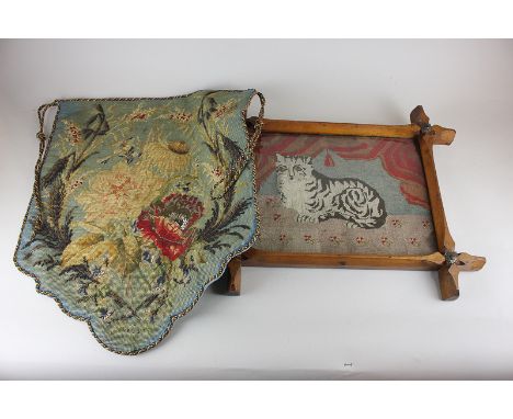 An embroidery and beaded shield shaped banner from a pole fire screen, together with an embroidered cat tapestry in carved wo