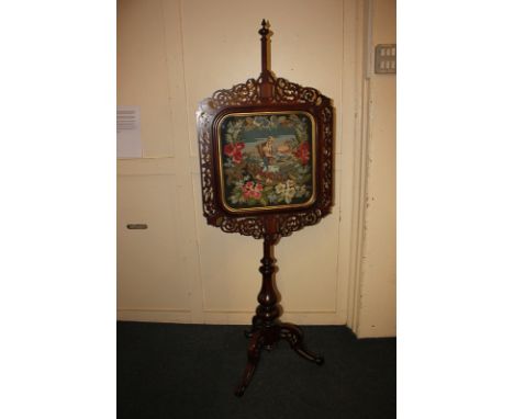 A Victorian rosewood tapestry fire screen with glazed tapestry mountain view, fruit picker and flowers