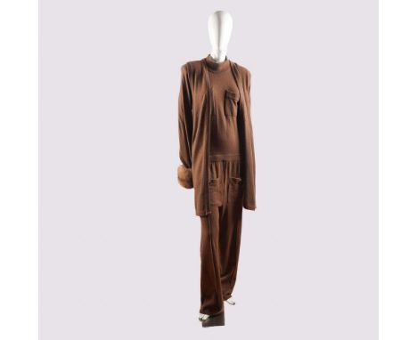 Offered is a luxurious two-piece ensemble crafted from cashmere and made in Italy, featuring a rich brown hue that exudes und