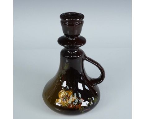 This Weller Pottery candlestick holder is a fine example of the Louwel line, featuring a rich brown glossy glaze with a hand-