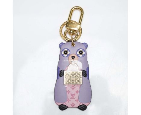 An adorable bag charm and key chain  showcasing the beloved Marmott with monogram floral eyes. The richly detailed design fea
