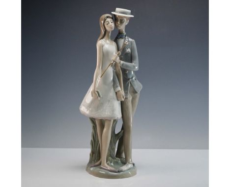Glazed finish sculpture depicting a young couple strolling, the gentleman hold a cane topped with a pearl. Lladro backstamp. 