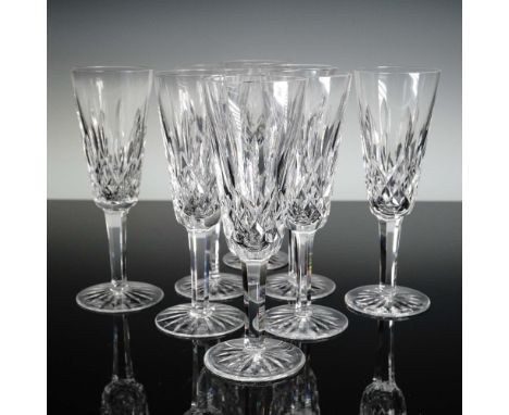 Set of eight Waterford crystal fluted champagne glasses in the Lismore pattern. Each glass features the classic vertical and 