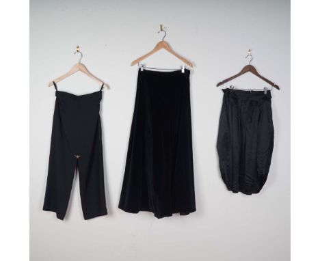 A striking vintage ensemble of black designer women's bottoms featuring three distinct pieces. The lot includes: a structured