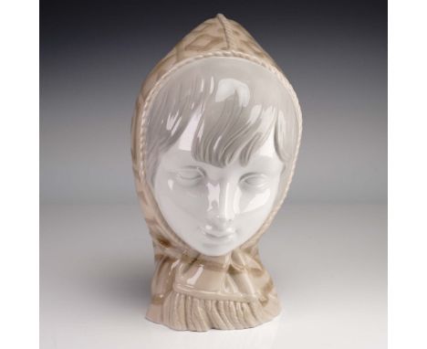 Bust of young girl with winter cap designed in brown and tan. Lladro impressed mark on base. Issued: 1968Dimensions: 8.5"HCou