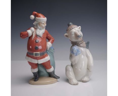 This charming two piece set features a hand painted Lladro porcelain Santa standing with his toy sack and a whimsical bear cl