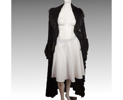Vintage-inspired full-length coat in dark brown, crafted from a patchwork of leather-fur panels with a soft, supple texture. 