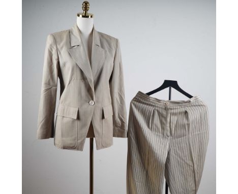 This sophisticated Valentino Boutique pant suit exudes classic elegance, featuring a tailored beige blazer with subtle pinstr