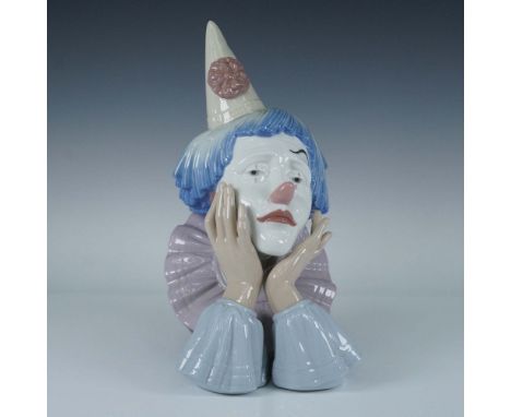 Lladro porcelain figurine 5129 presents a poignant bust of a sad jester with a wistful expression, captured in a glossy paste