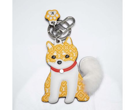 Charming Louis Vuitton keychain featuring a playful Shiba Inu dog adorned with the signature monogram canvas and vibrant yell