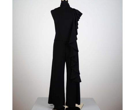 This striking Julian Chang black jumpsuit features a modern one-shoulder silhouette with a dramatic cascading ruffle that flo