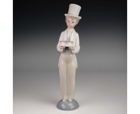 This elegant Lladro porcelain figurine titled Happy Birthday presents a smiling young gentleman dressed in formal attire, com