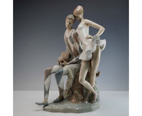 Glazed finished figure depicting a harlequin and a ballerina in love. He plays the mandolin as she carefully leans on him. Ll