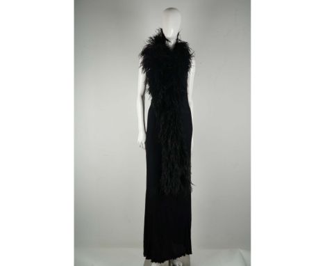 Striking and sophisticated, this black evening gown by Ana Beltrao features a dramatic full-length silhouette with delicate s