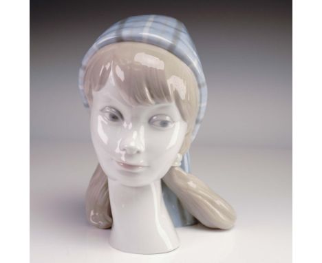Issued in 1968, this elegant porcelain figurine by Lladro is titled Girl's Head and features the work of sculptor Vicente Mar