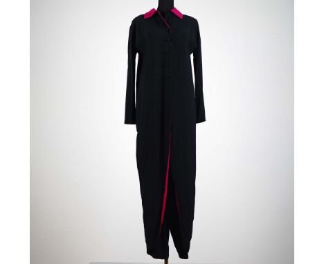 This striking vintage ensemble by Shirley Parker London features a sleek black jumpsuit paired with a dramatic full-length bl
