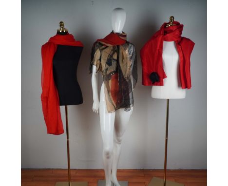 A refined lot of three designer scarves presented in four pieces, blending visual drama with elegant craftsmanship. The colle