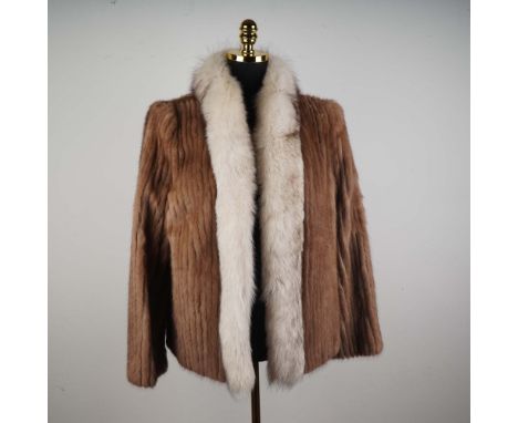 Luxuriously crafted from genuine Saga Mink, this vintage-style fur jacket embodies classic elegance with a touch of Arctic dr