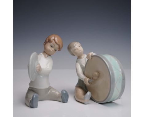 This charming Lladro porcelain figurine duo depicts two seated children in soft pastel glazes, one striking a pair of cymbals