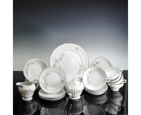 A lovely 27-piece porcelain dinnerware set by Three Castle China of Japan, featuring the elegant "Wild Rose" pattern. Each pi