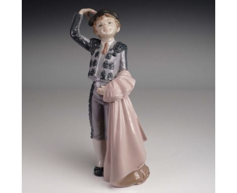 This exquisite Lladro porcelain figurine portrays a youthful matador in full traje de luces, tipping his montera in a gracefu